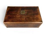 an old wooden box sitting on top of a white surface