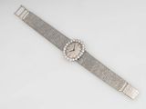 a close up of a wrist watch on a white surface