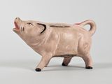une petite figurine de cochon posée sur une table