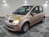 a picture of a small beige car parked in a garage