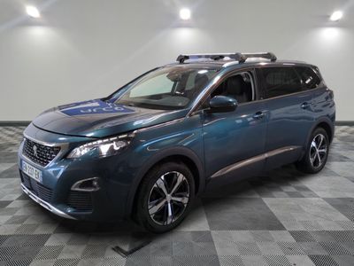 a blue suv parked in a garage with a black checkered floor