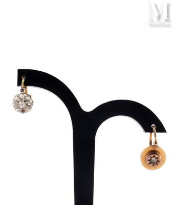 a close up of a pair of earrings on a stand