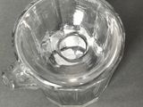a glass cup that is sitting on a table