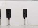 a white box with three black speakers on top of it