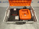 an orange case with a battery and a charger in it