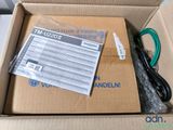 a box with a cable and a charger inside of it