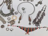 many different types of jewelry on a white surface