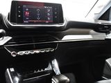 the interior of a car with a touch screen and a steering wheel
