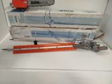 two chainsaws sitting on top of a stack of boxes
