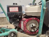 a machine that is sitting on the ground next to a wall