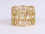yellow gold ring with white diamonds on a white background