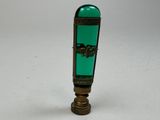 a green glass bottle with a horse design on it