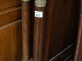 two wooden poles that are standing next to each other