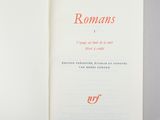 an open book with a red writing on it sitting on a table