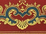 a red book with gold and blue designs on it