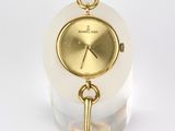 an image of a white and gold watch with a key on it