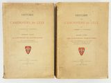 two old books are open on a white surface