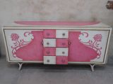 a pink and white dresser with drawers and drawers on it
