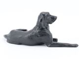 black dog figurine on a white surface with a white background