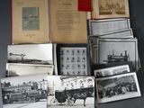 a lot of old black and white photos on the table