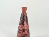 a red vase with black flowers on it on a white background