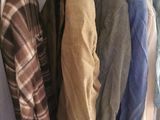 a lot of clothes hanging on a rack in a closet