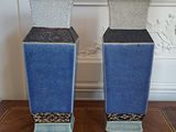 two vases that are sitting on a wooden table