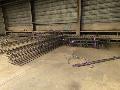 a large pile of steel rods sitting in a warehouse