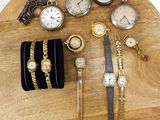 many different types of watches and bracelets on a wooden table