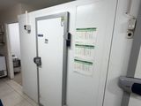a man that is standing in front of a white door