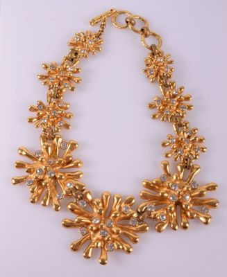 a gold necklace on a white background