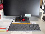 a computer desk with a keyboard and a monitor on it