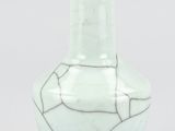 a white vase with a cracky design on it