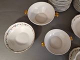 many plates and bowls arranged on a table