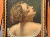 portrait of a young woman in a white dress on a wooden easel