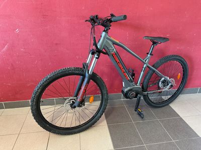 the bike is parked against the wall in front of a red wall