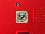 a close up of a red phone with a mickey mouse sticker on it
