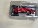 a red toy car in a plastic container on a table