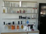 many bottles of hair products on a shelf in a room