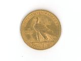 a gold coin with a bird on it on a white surface