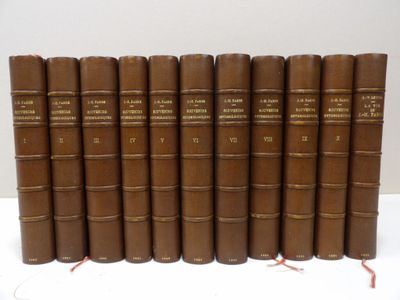 six brown books are lined up on a white surface