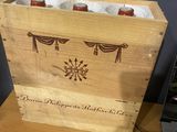 a wooden box with two bottles of beer inside of it