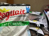 a bag of cream sitting on a shelf next to a pile of other items