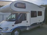 an image of a camper van parked in a driveway