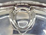 a close up of a silver plate on a table