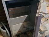 a small oven sitting in the middle of a room