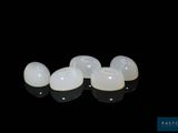 a close up of a pair of implants on a black surface