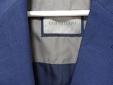 a close up of a blue suit with a label on it
