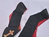 pair of black and red ties with gold crosses on them