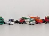 many small toy cars lined up on the wall